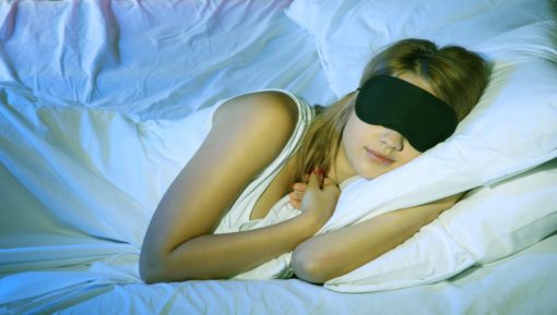 Young beautiful woman with eye mask sleeping on bed in bedroom – Depositphotos_13871249_xl-2015