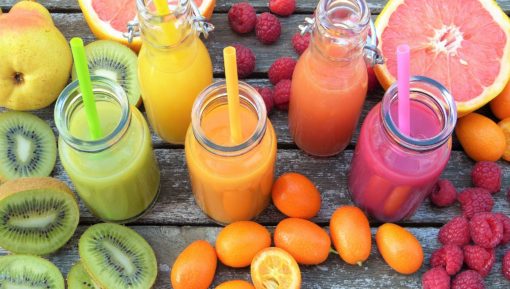 Photo of five different types of smoothie, with the fruit used to make them