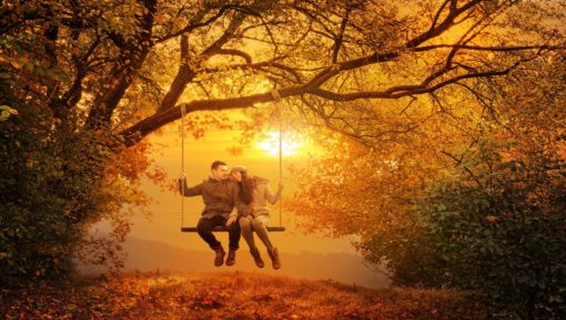 Romantic couple swing in the autumn park