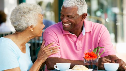 Senior Couple Enjoying Snack At Outdoor Cafe