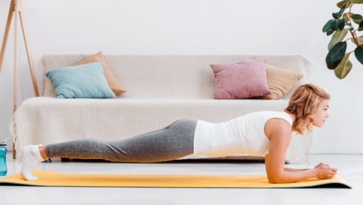 Attractive woman in sportswear doing plank